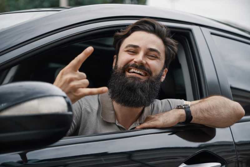 close up side portrait happy man driving car