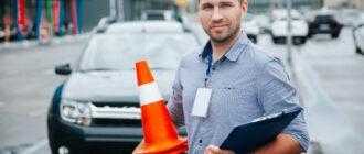 driving instructor collecting plastic cones