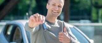 happy man with car key street