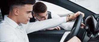 two men stand showroom against cars close up sales manager suit that sells car customer seller gives key customer