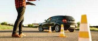 instructor helps female student drives cones lesson driving school