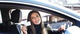 joyful girl driving training car with drivers license card her hands 1