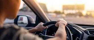 man driving car along highway with sun shines windshield