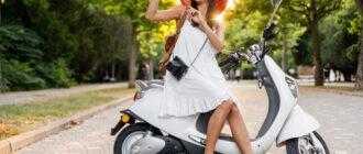 attractive woman riding motorbike street summer vacation style traveling smiling happy having fun stylish outfit adventures taking pictures vintage photo camera