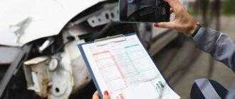woman photographs broken car smartphone holds insurance documents